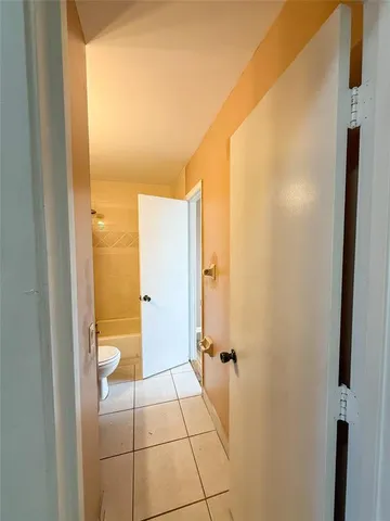 a bathroom with a granite countertop shower and a toilet