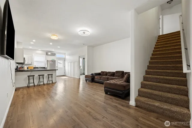 a kitchen with granite countertop white cabinets and white appliances
