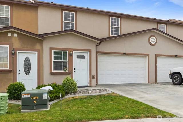 a kitchen with granite countertop a refrigerator sink and cabinets
