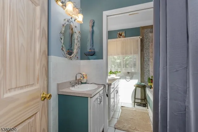 a bathroom with a sink a mirror and a window