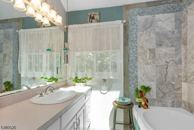 a bath room with a sink and a mirror