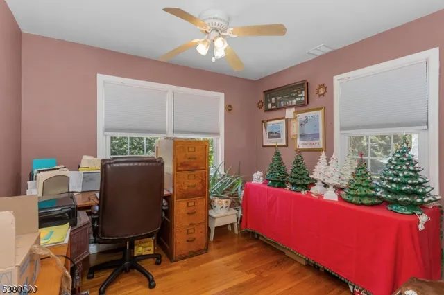 a view of a workspace with furniture and a window