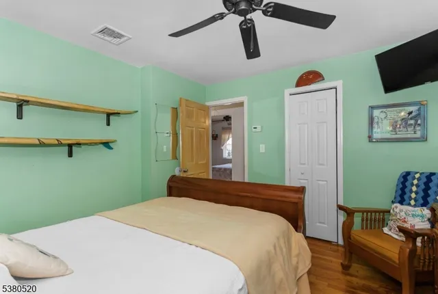 a bedroom with a bed and a television