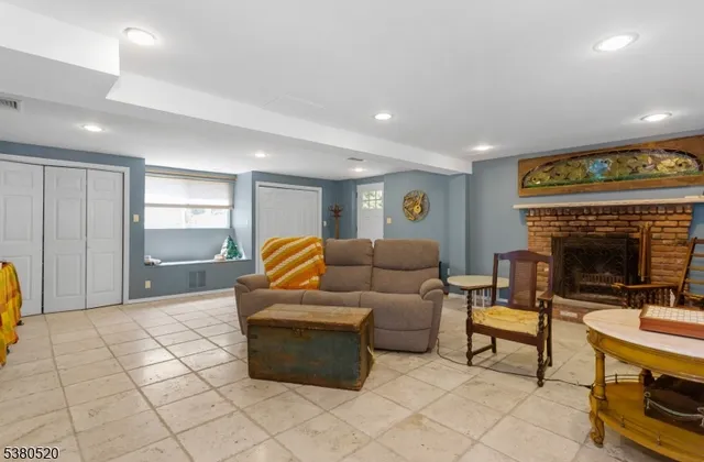 a living room with furniture a dining table and a fireplace