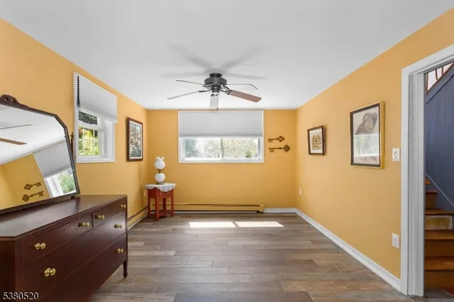 a view of workspace with window and wooden floor