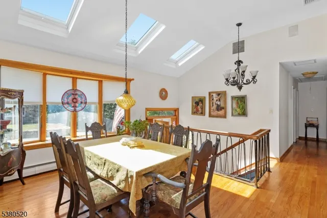a view of a dining room with furniture wooden floor and chandelier