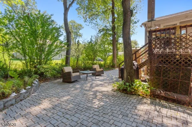 a view of a chair and table in the garden