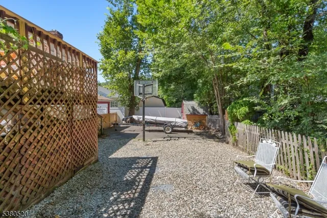 a view of backyard with a deck and chair