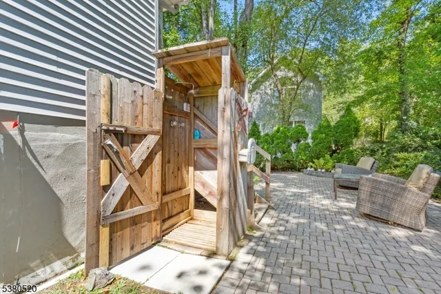 a view of a house with a small yard and a garden