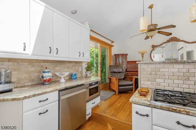a kitchen with white cabinets and appliances