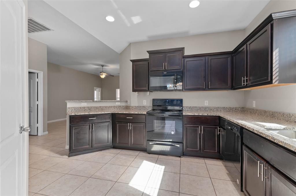 4700 Conley Lane Denton, TX 76207 - Photo 4 of 17 a kitchen with a sink and cabinets