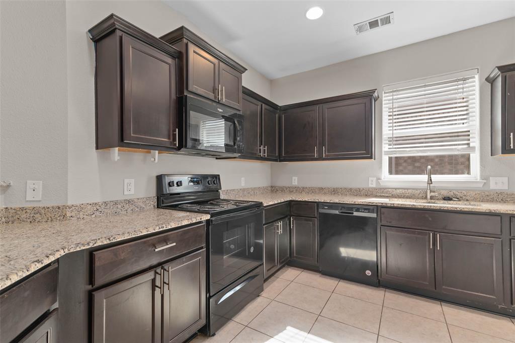 4700 Conley Lane Denton, TX 76207 - Photo 5 of 17 a kitchen with a sink stove top oven and cabinets