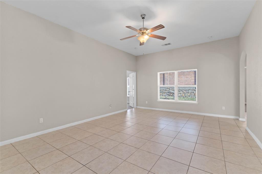 4700 Conley Lane Denton, TX 76207 - Photo 6 of 17 an empty room with windows and fan