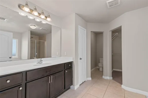 a bathroom with a sink vanity and a mirror