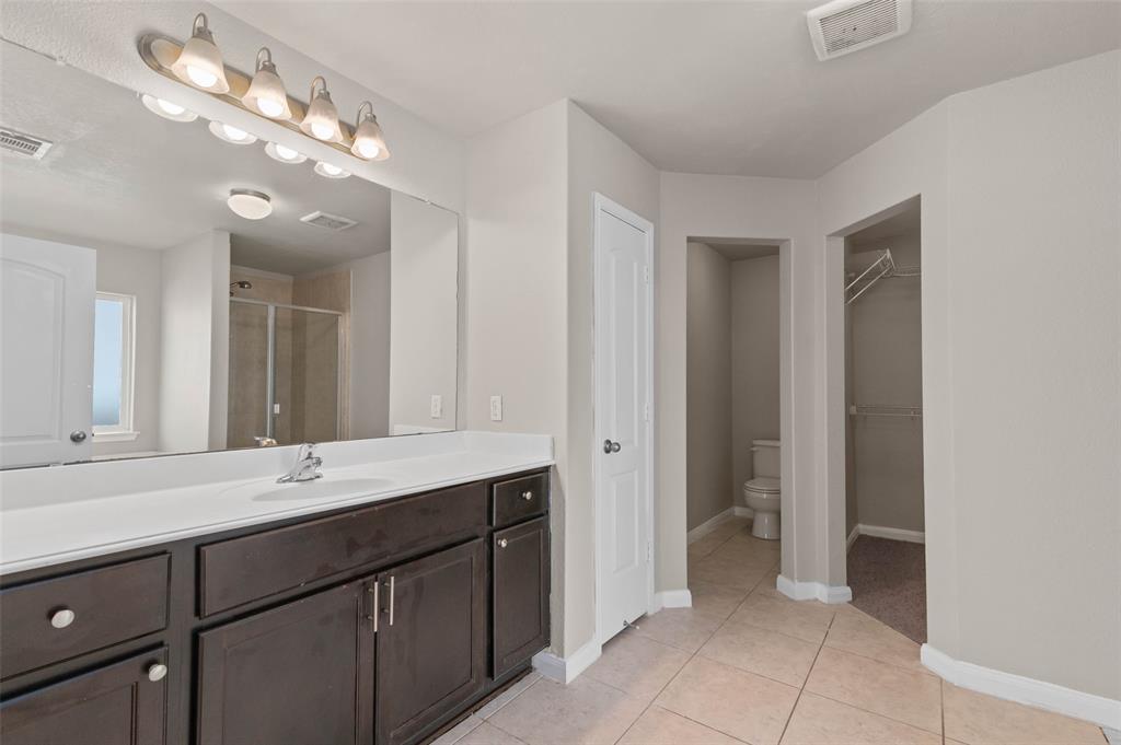 4700 Conley Lane Denton, TX 76207 - Photo 9 of 17 a bathroom with a sink vanity and a mirror