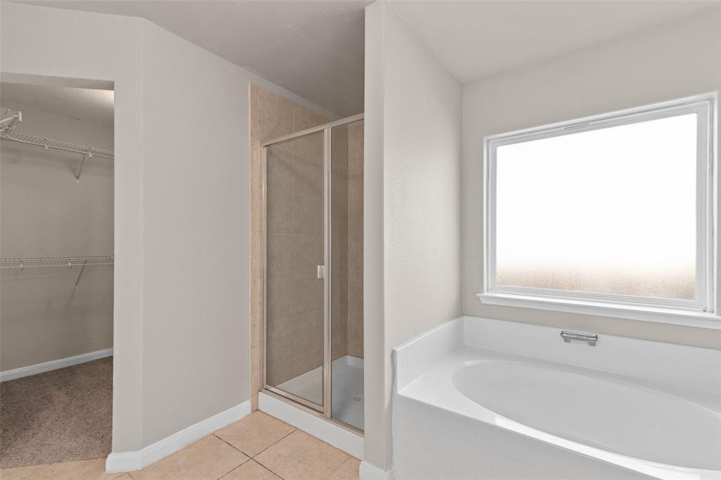 4700 Conley Lane Denton, TX 76207 - Photo 10 of 17 a bathroom with a bathtub and a shower
