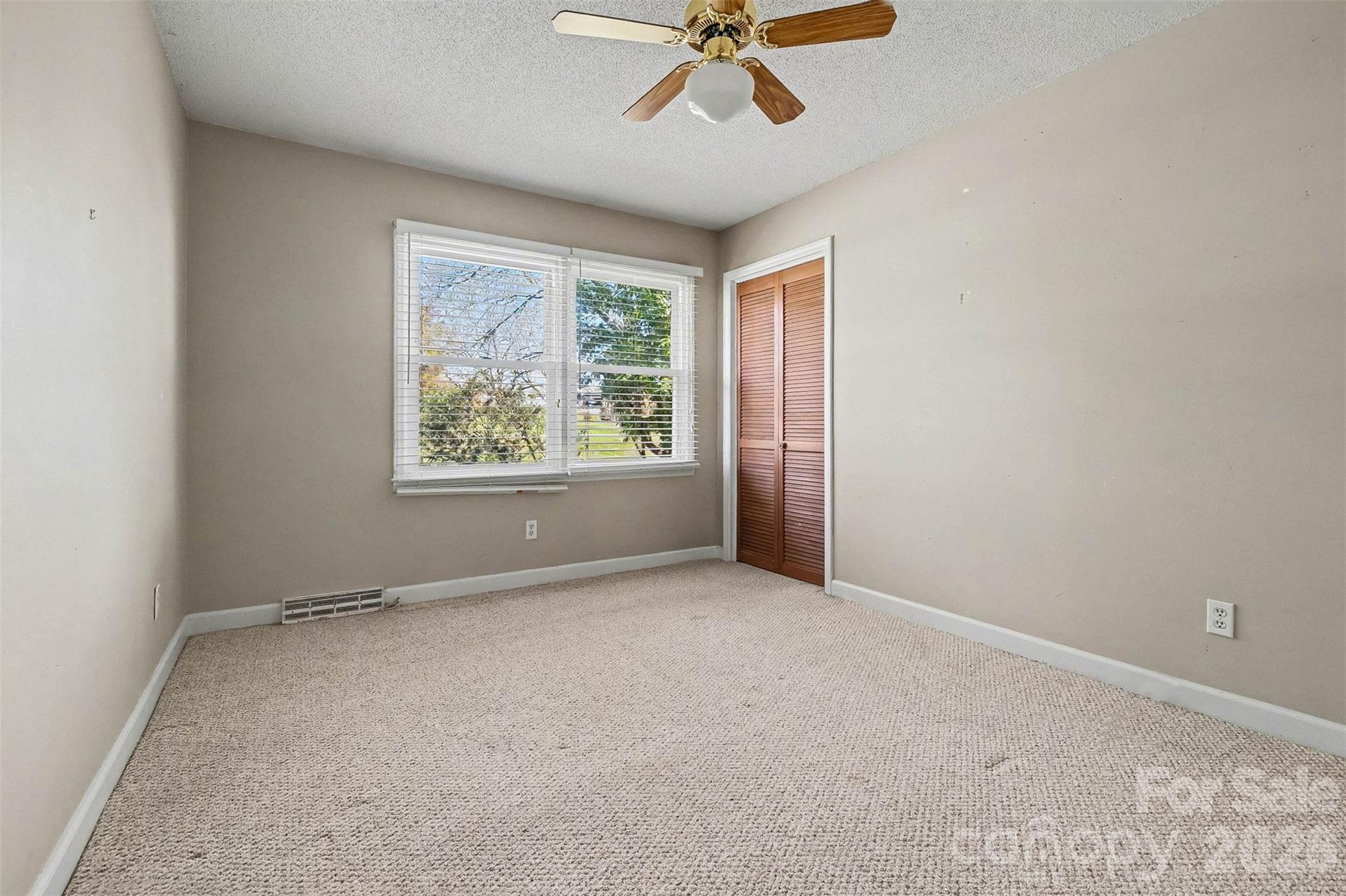 1388 Smith Farm Road Lincolnton, NC 28092 - Photo 12 of 19 an empty room with windows and fan