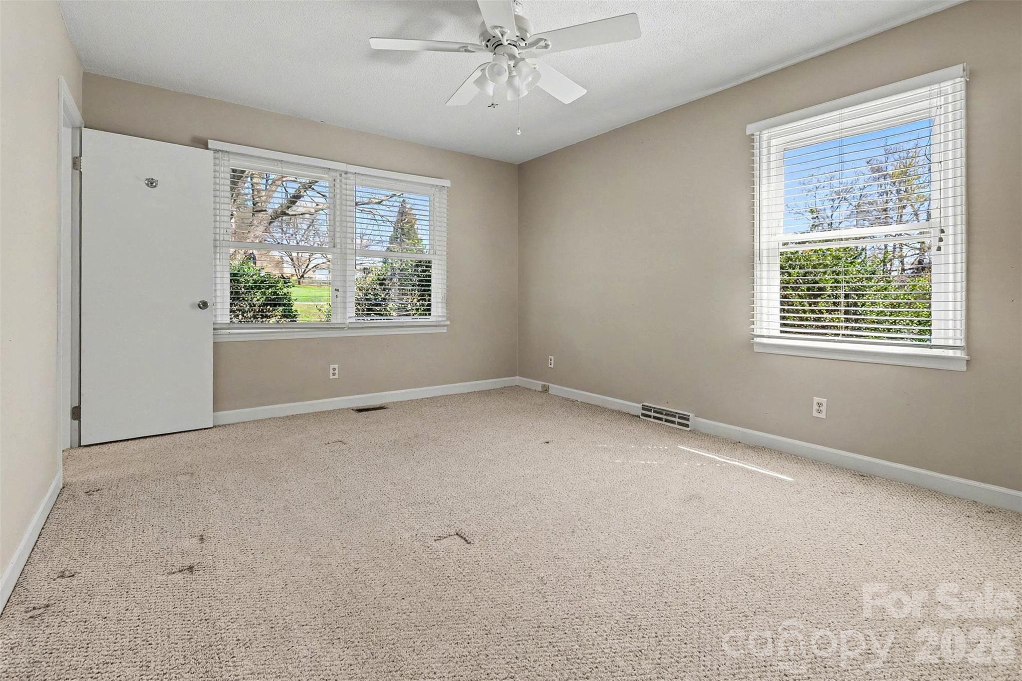 1388 Smith Farm Road Lincolnton, NC 28092 - Photo 5 of 19 an empty room with a window and a ceiling fan