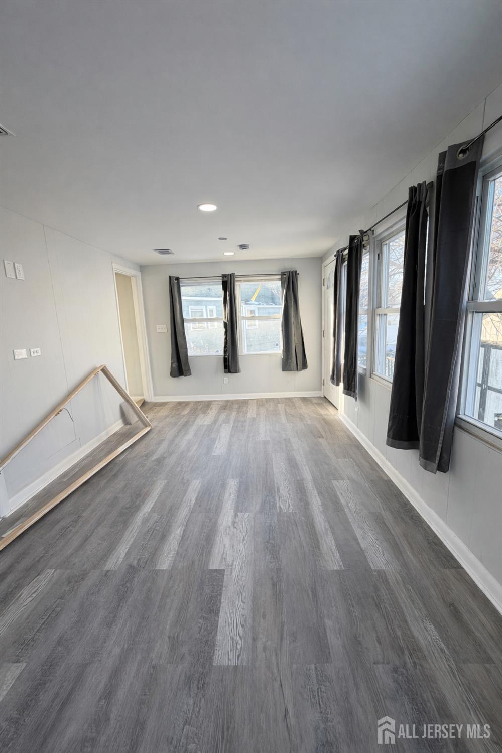 30 Falmouth Road Iselin, NJ 08830 - Photo 11 of 23 wooden floor in an empty room with a window