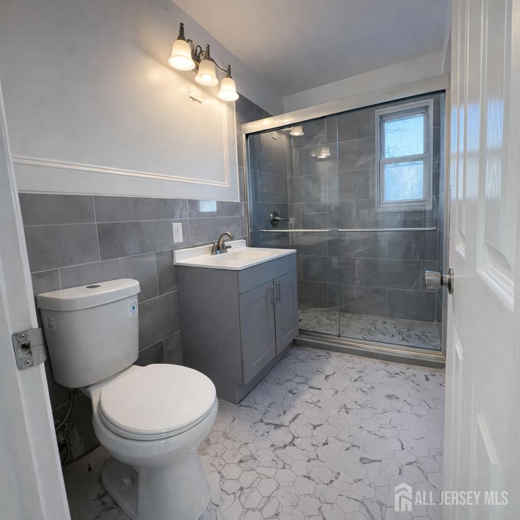 30 Falmouth Road Iselin, NJ 08830 - Photo 12 of 23 a bathroom with a sink a toilet and shower