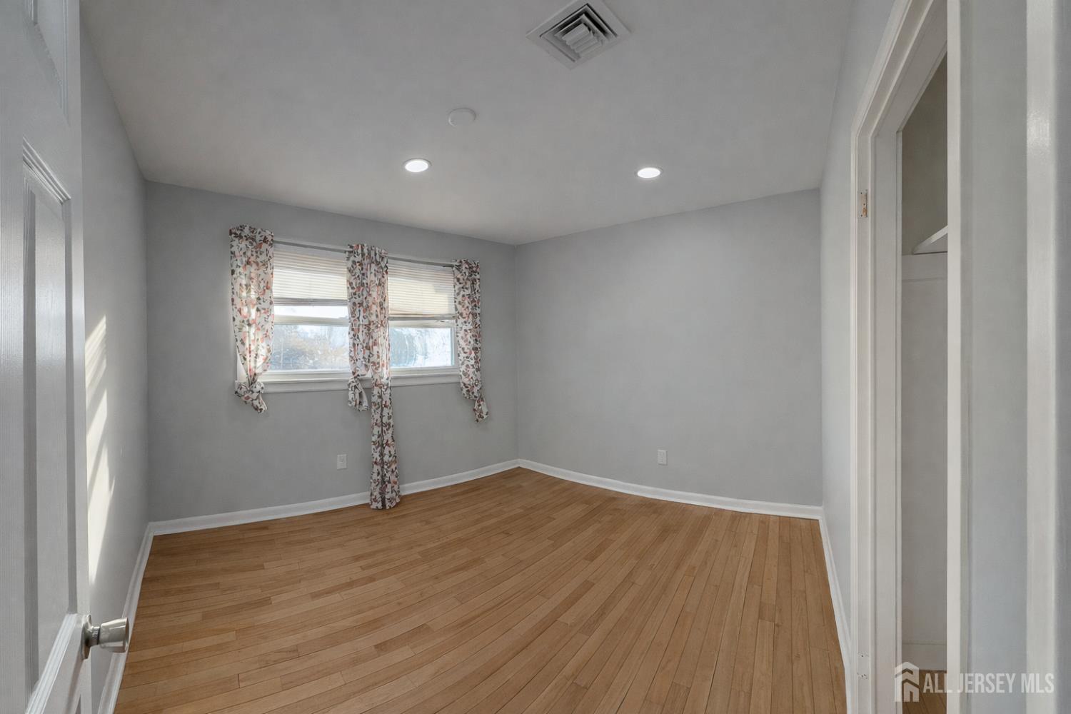 30 Falmouth Road Iselin, NJ 08830 - Photo 14 of 23 a view of empty room with wooden floor and fan