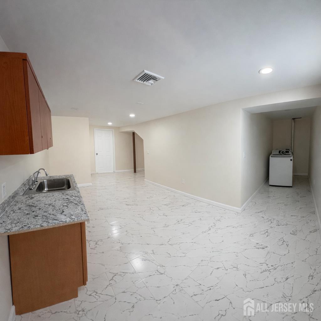 30 Falmouth Road Iselin, NJ 08830 - Photo 18 of 23 a kitchen with stainless steel appliances granite countertop a sink and cabinets