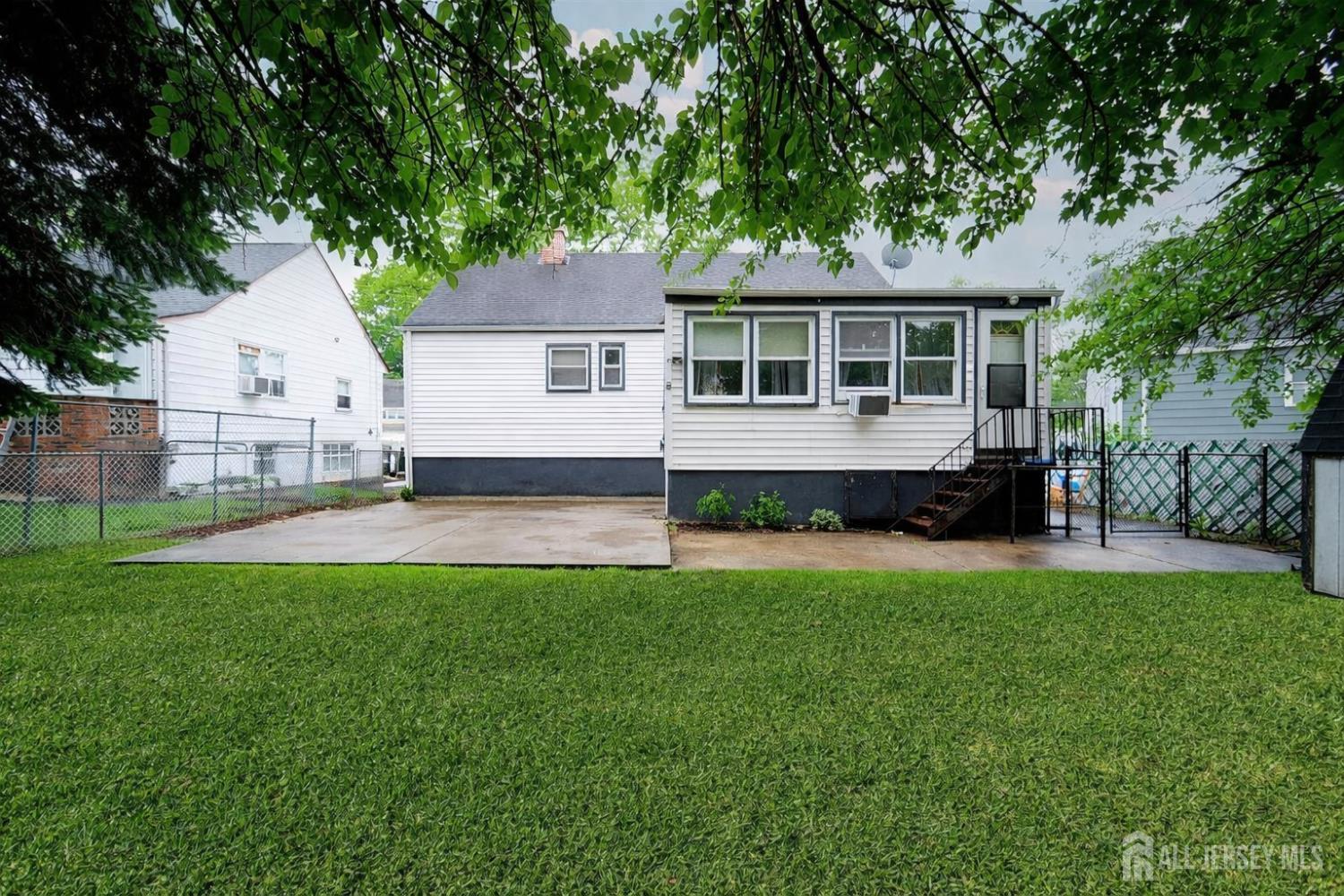 30 Falmouth Road Iselin, NJ 08830 - Photo 2 of 23 a front view of a house with a yard and trees