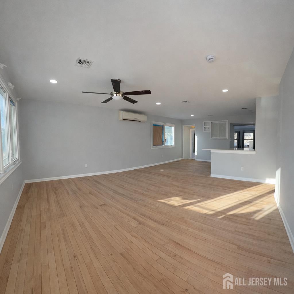30 Falmouth Road Iselin, NJ 08830 - Photo 4 of 23 an empty room with wooden floor and windows