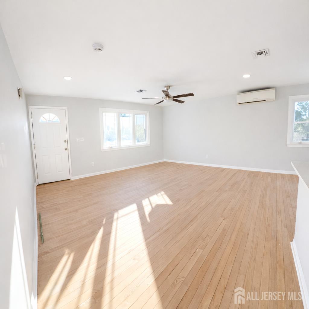 30 Falmouth Road Iselin, NJ 08830 - Photo 5 of 23 an empty room with wooden floor and windows