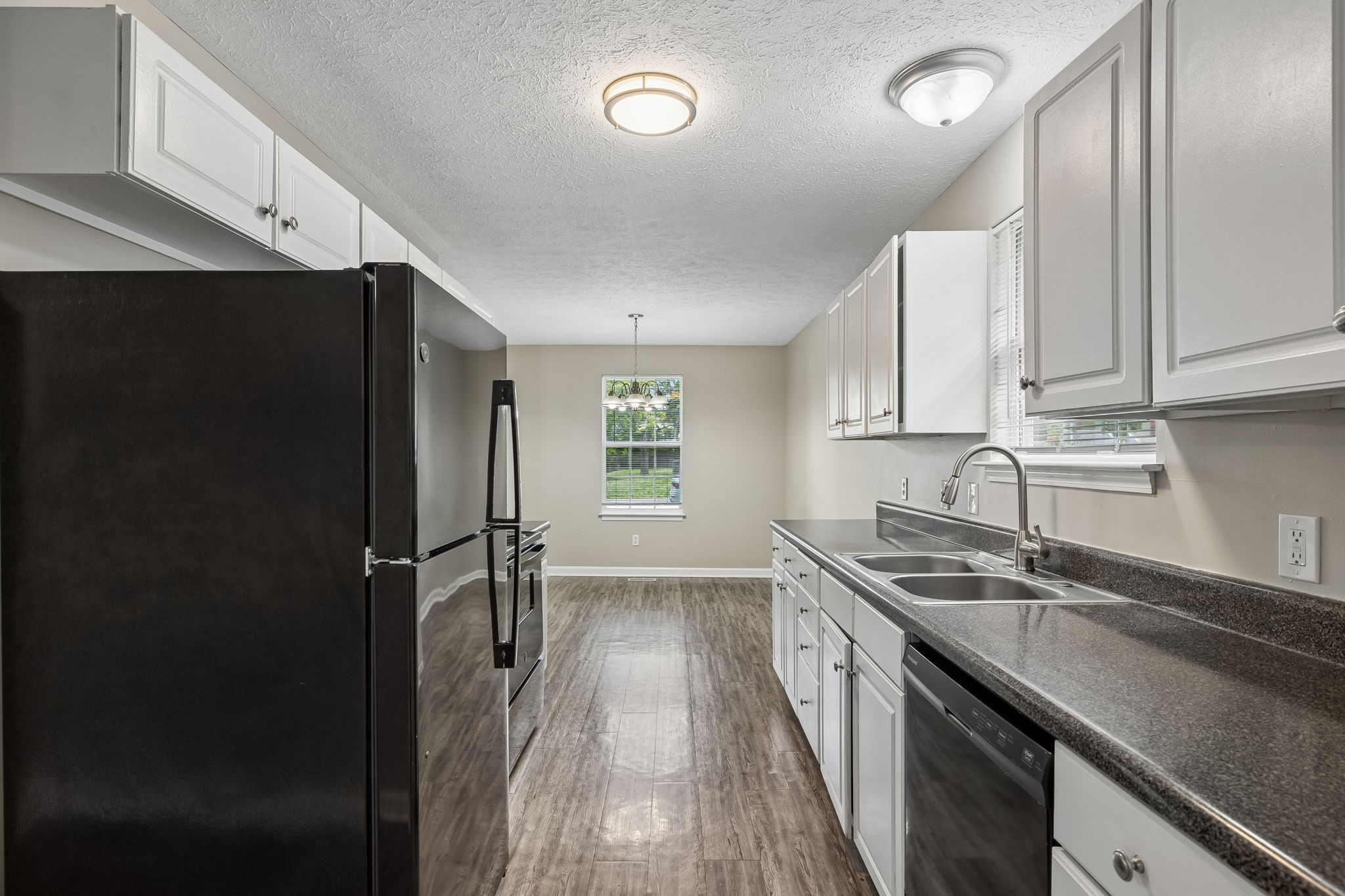 511 Hayes Street Springfield, TN 37172 - Photo 11 of 26 a kitchen with a sink a refrigerator and cabinets