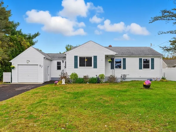 a front view of a house with a garden