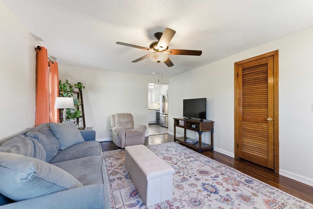 97 Robak Drive Chicopee, MA 01020 - Photo 12 of 41 a living room with furniture a flat screen tv and a rug