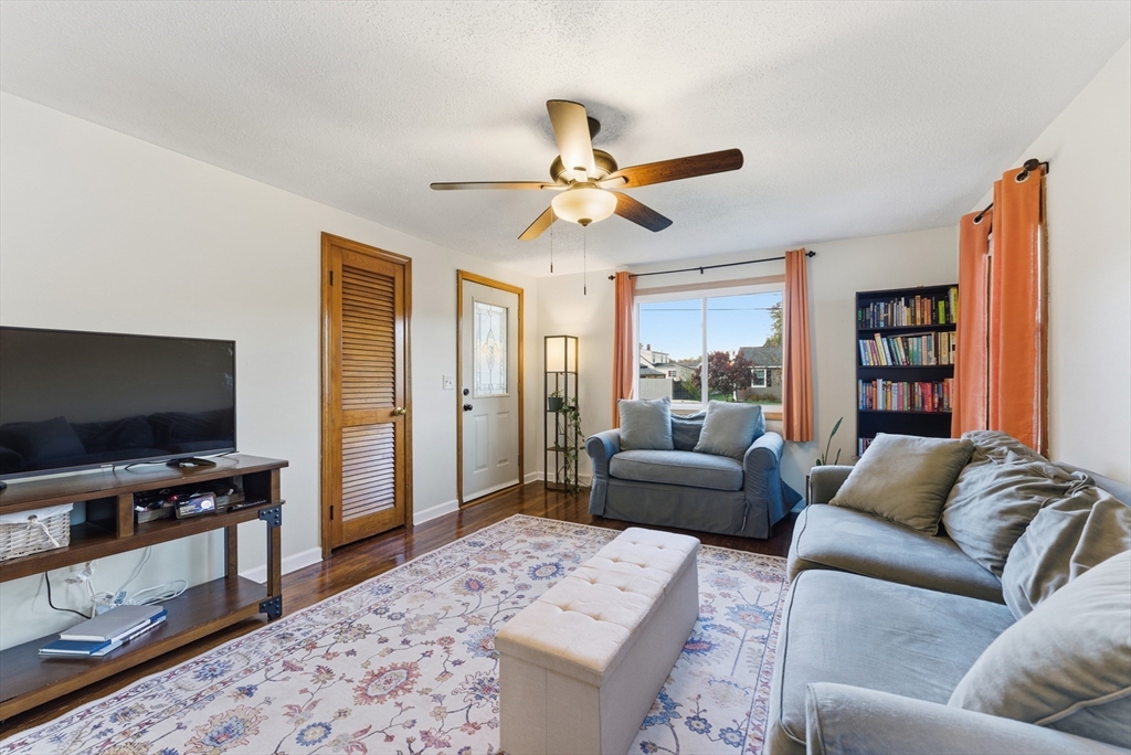 97 Robak Drive Chicopee, MA 01020 - Photo 13 of 41 a living room with furniture a flat screen tv and a rug