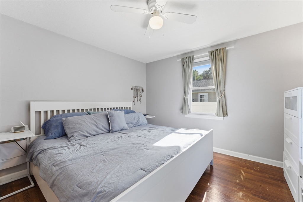 97 Robak Drive Chicopee, MA 01020 - Photo 19 of 41 a bedroom with a large bed and a chandelier