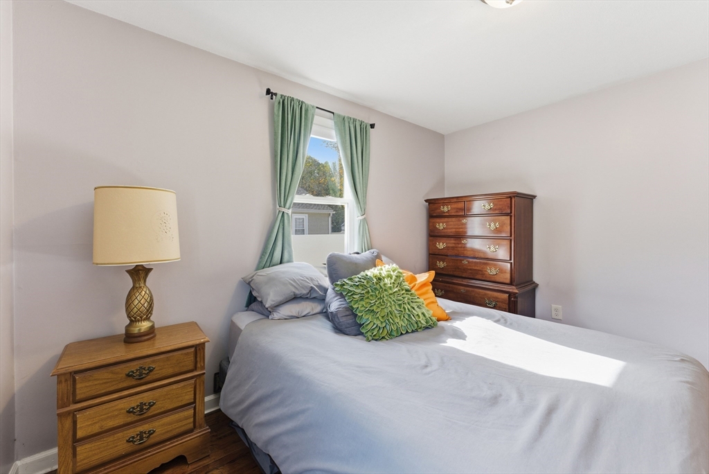 97 Robak Drive Chicopee, MA 01020 - Photo 26 of 41 a bedroom with a bed and wooden floor