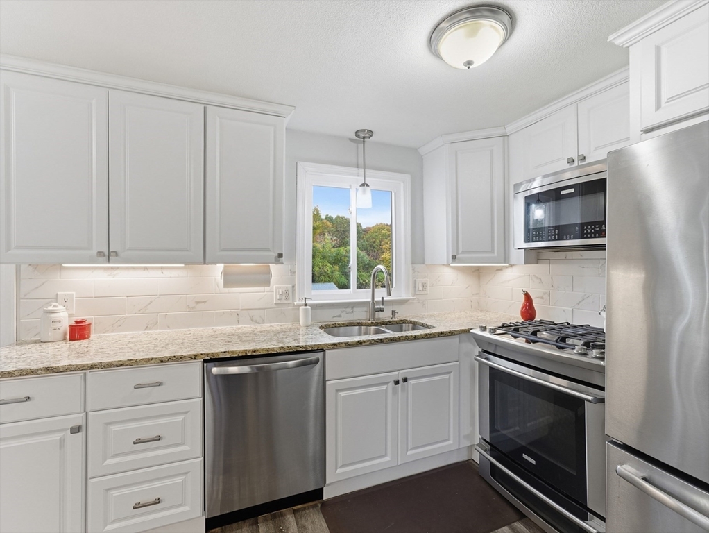 97 Robak Drive Chicopee, MA 01020 - Photo 3 of 41 a kitchen with stainless steel appliances white cabinets and a sink
