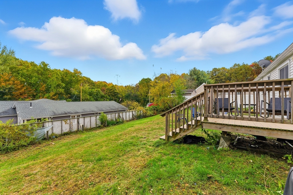 97 Robak Drive Chicopee, MA 01020 - Photo 32 of 41 a view of a house with wooden deck and a big yard