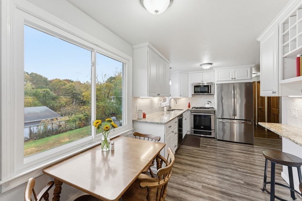 97 Robak Drive Chicopee, MA 01020 - Photo 5 of 41 a kitchen with a table chairs refrigerator and microwave