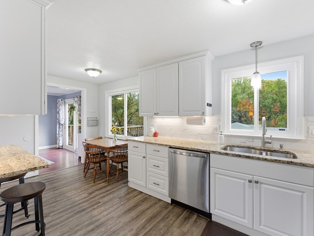 97 Robak Drive Chicopee, MA 01020 - Photo 6 of 41 a kitchen with sink cabinets and wooden floor