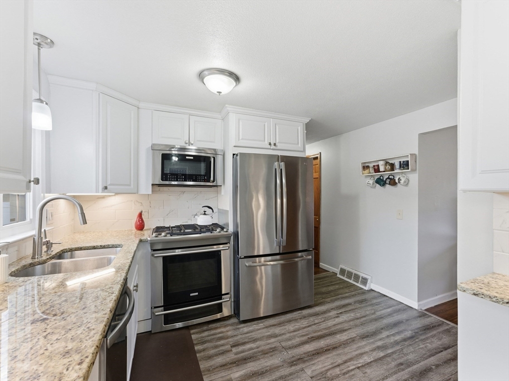 97 Robak Drive Chicopee, MA 01020 - Photo 7 of 41 a kitchen with granite countertop a refrigerator stove and sink