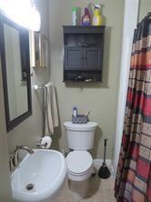 3760 Cedar Hurst Way Atlanta, GA 30349 - Photo 14 of 22 a bathroom with a toilet sink and mirror