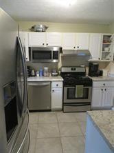 3760 Cedar Hurst Way Atlanta, GA 30349 - Photo 2 of 22 a kitchen with a stove and a microwave