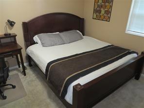 3760 Cedar Hurst Way Atlanta, GA 30349 - Photo 7 of 22 a bedroom with a bed and painting on the wall