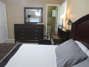3760 Cedar Hurst Way Atlanta, GA 30349 - Photo 8 of 22 a bedroom with a bed and a mirror on dresser