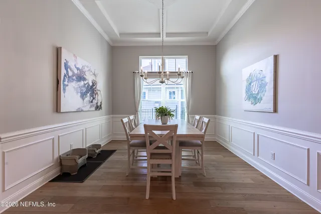 a spacious bedroom with a large bed and a chandelier fan