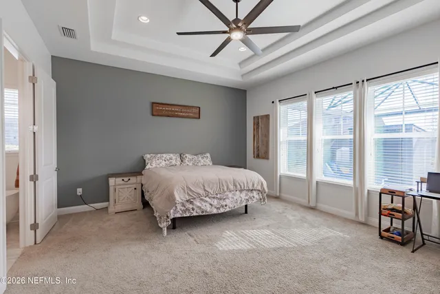 a bedroom with furniture and flat screen tv
