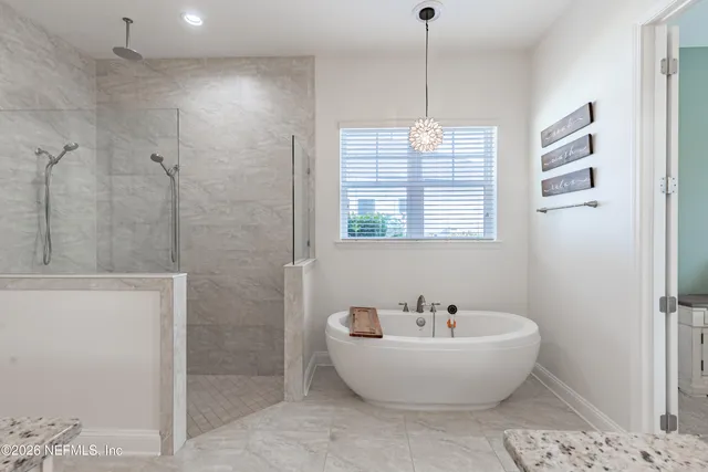 a bathroom with a granite countertop sink vanity and mirror