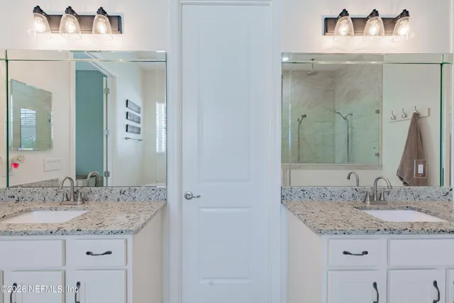 a spacious bathroom with a tub sink and mirror