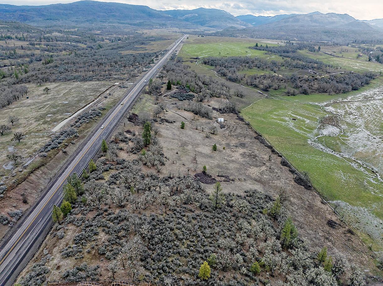 13546 Highway 140 Eagle Point, OR 97524 - Photo 8 of 24 a view of a mountain with a field