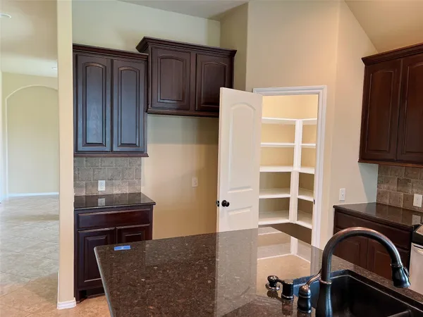 a view of kitchen and sink wooden cabinets